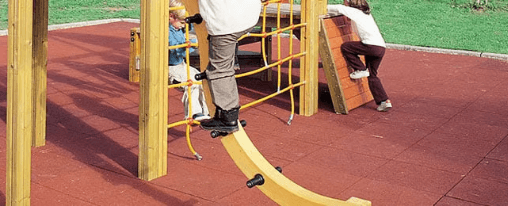 Fallschutzplatten auf einem Spielplatz unter verschiedenen Spielplatzger&auml;ten wie Schaukeln und Rutschen
