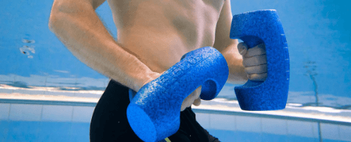 Zwei Personen trainieren im Schwimmbecken mit Wasserhanteln w&auml;hrend einer Aquafitness-Einheit