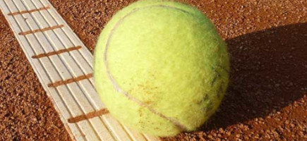 Tennisball liegt auf dem Boden eines Tennisplatzes