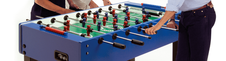 Mehrere Personen spielen gemeinsam Tischfußball an einem Kickertisch – ideal für Freizeit, Familie und Freunde